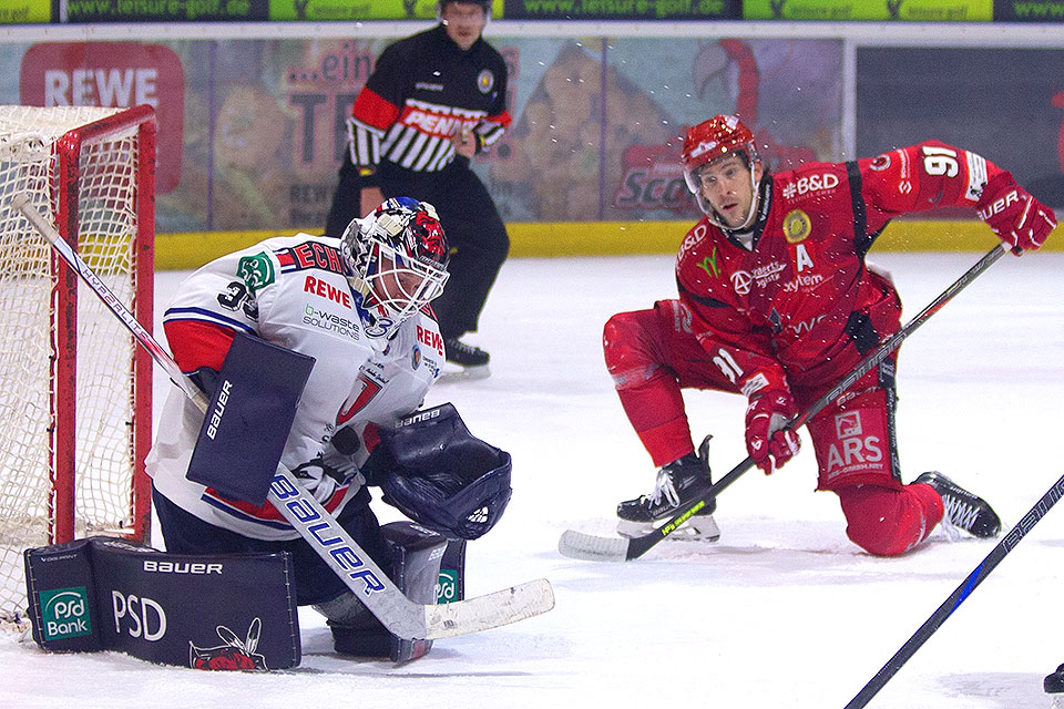 Der berragende Indians-Torwart Timo Herden hat den Puck vor Scorpion Cameron.